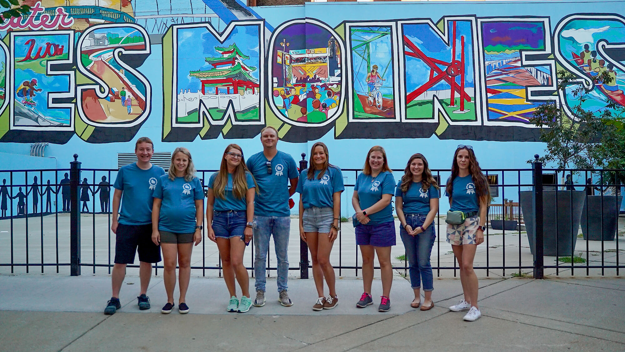 Neapolitan Labs team in front of Des Moines mural