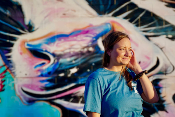 Our director, enterprise sales poses in front of a mural at the 2021 Iowa State Fair