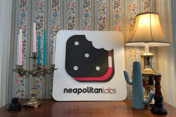 Neapolitan Labs sign on desk for business meeting.